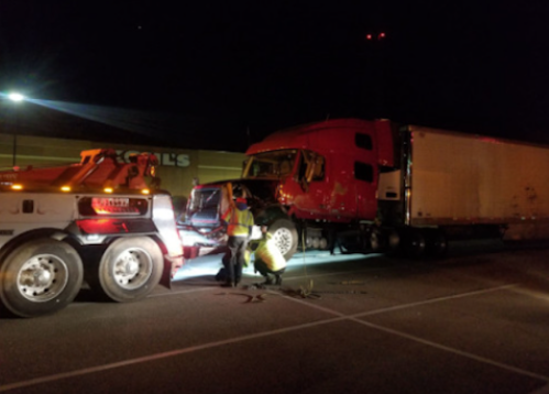 Night-time heavy duty semi truck recovery operation